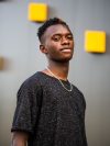 shallow focus shot of a young black male on a grey wall background